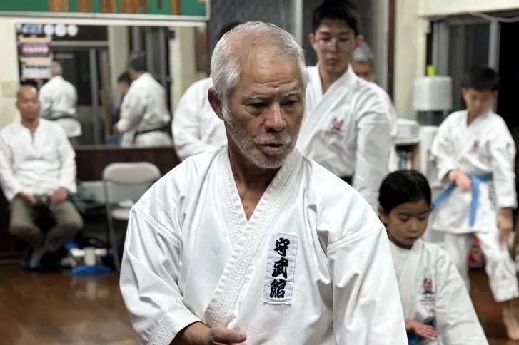 Image of KARATE practitioners of various ages training together